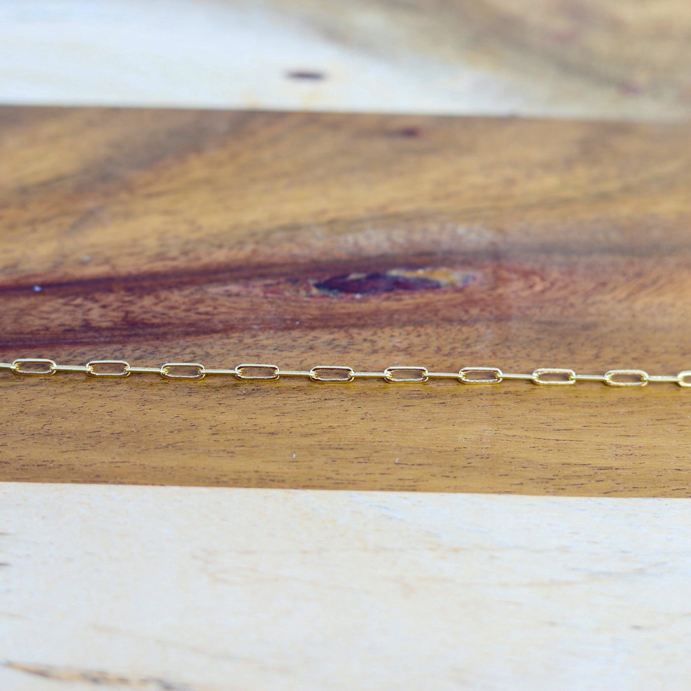 Gold chain on a wooden surface