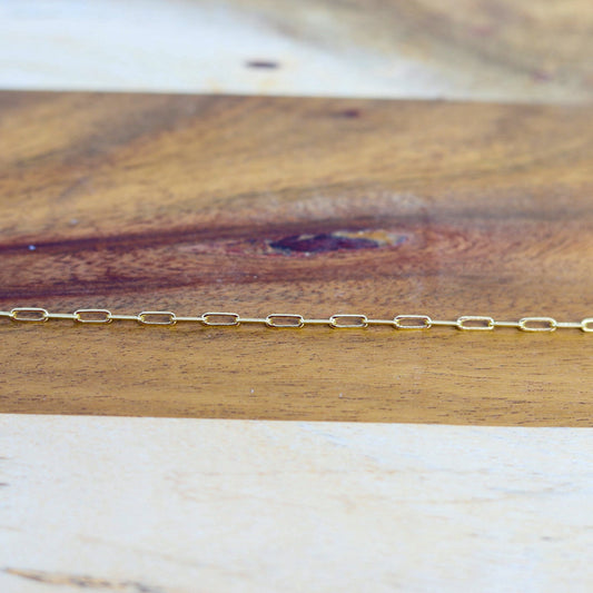 Gold chain on a wooden surface